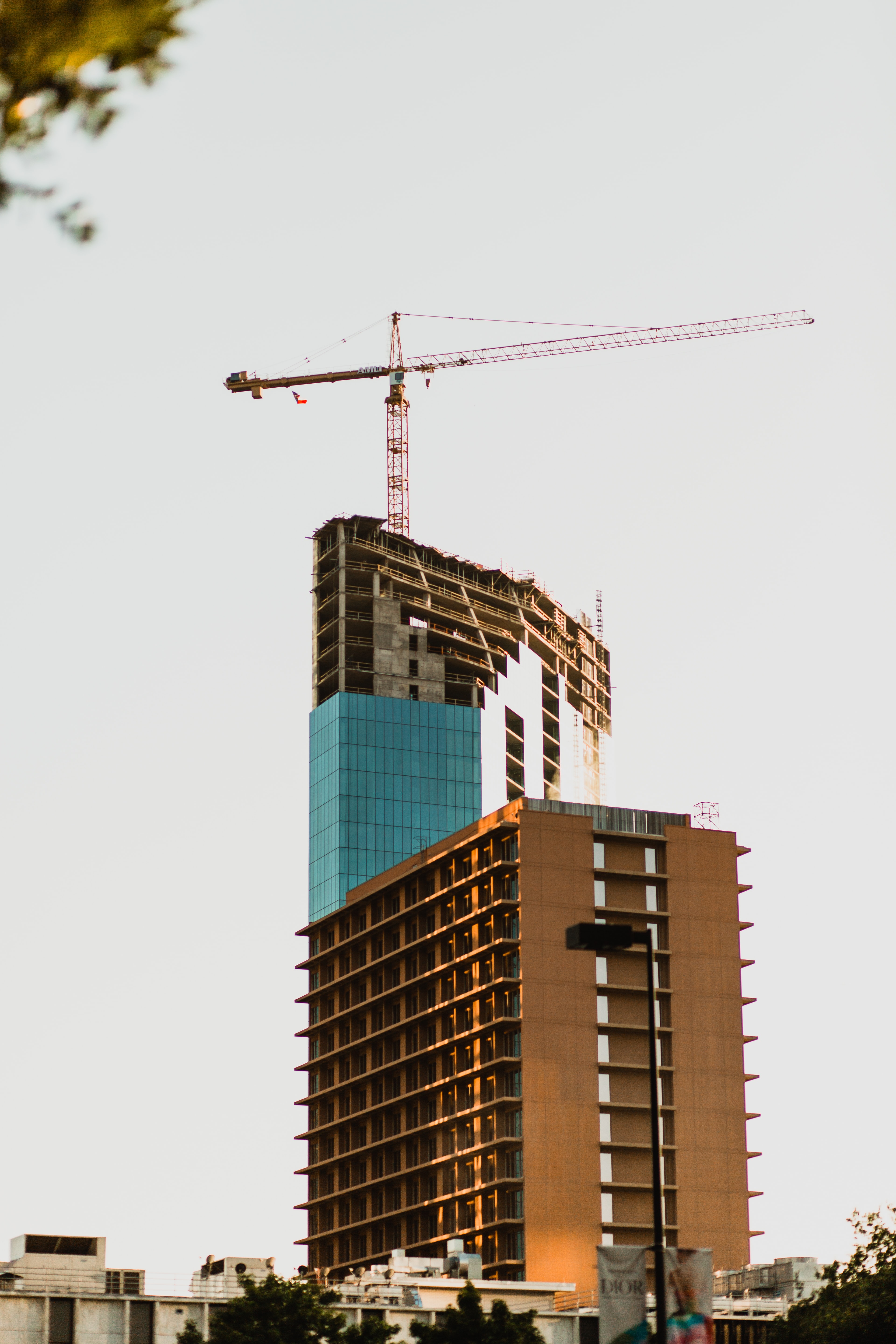 Image of a tall glass building in construction 