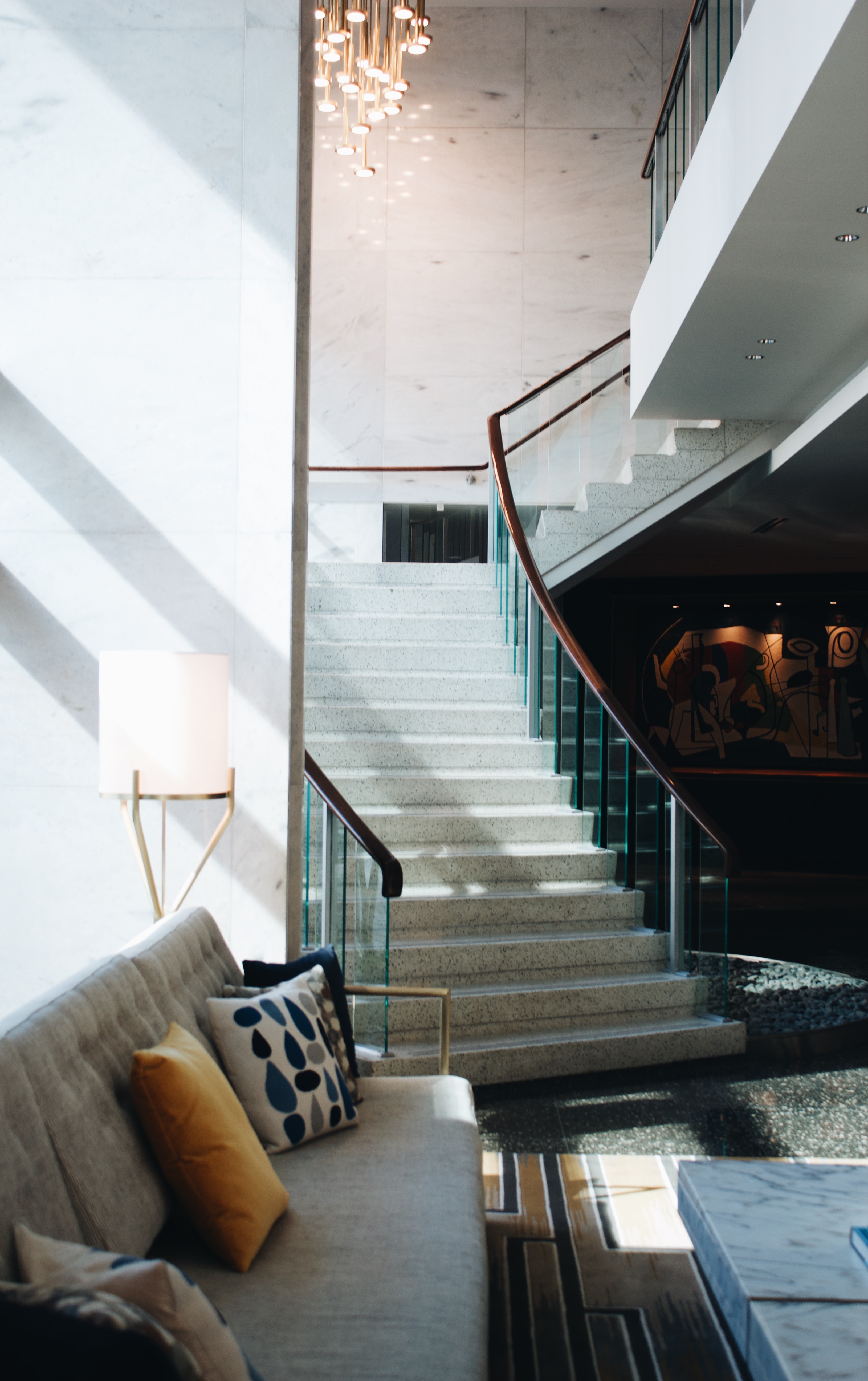 Lobby with a sofa and a modern staircase